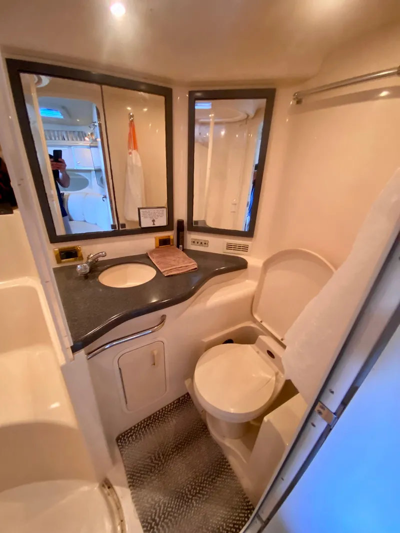 Slide: The Image of 1997 Sea Ray 400 Sundancer bathroom with sink, toilet, and mirror. - 28
