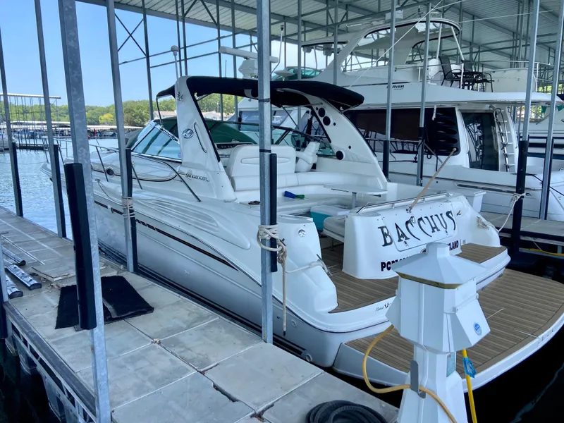 Slide: The Image of 1997 Sea Ray 400 Sundancer docked in a marina under a covered structure. - 3