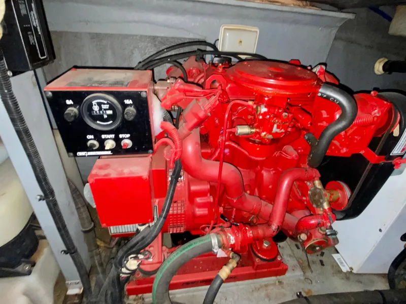 Slide: The Image of Engine compartment of a 1997 Sea Ray 400 Sundancer, featuring a red marine engine. - 32