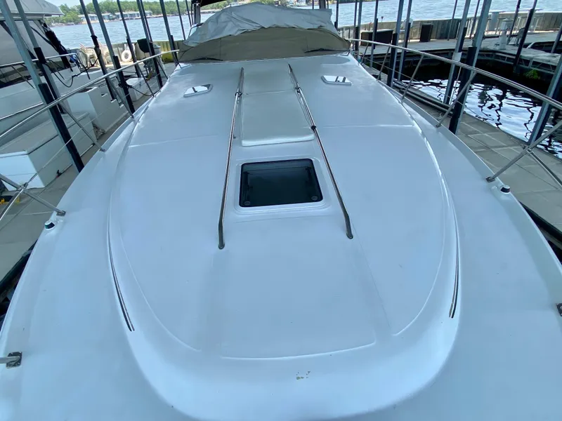 Slide: The Image of 1997 Sea Ray 400 Sundancer yacht deck with hatch, docked in marina. - 4