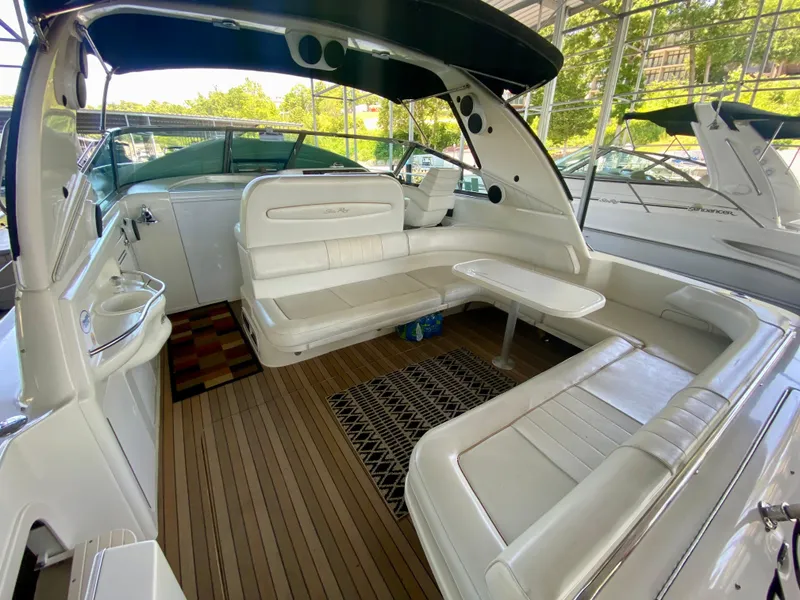 Slide: The Image of Luxurious 1997 Sea Ray 400 Sundancer yacht interior with white seating and wooden flooring. - 6