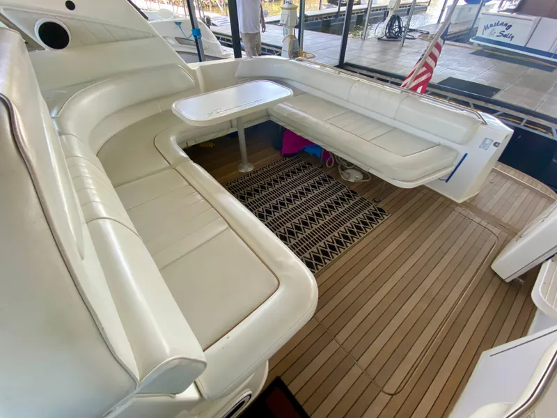 Slide: The Image of 1997 Sea Ray 400 Sundancer yacht with white leather seating and wooden deck. - 8
