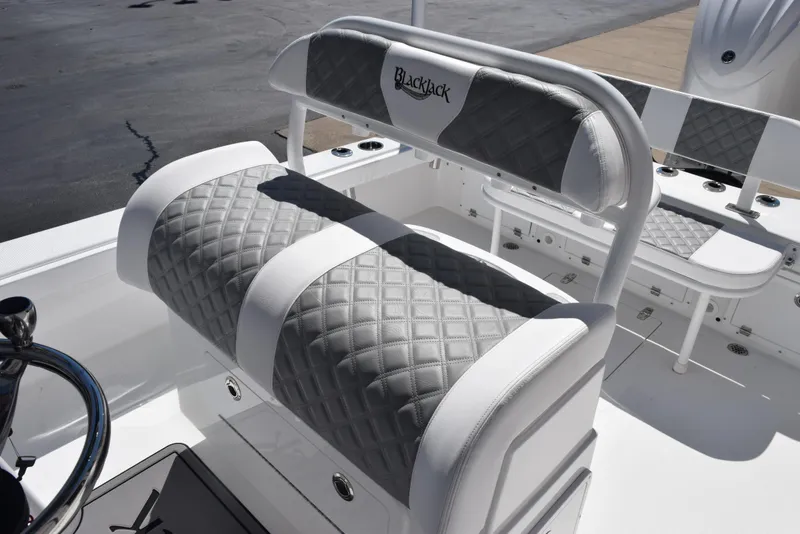 Slide: The Image of Luxury seating on 2025 BlackJack 256 Coastal boat with quilted upholstery. - 13