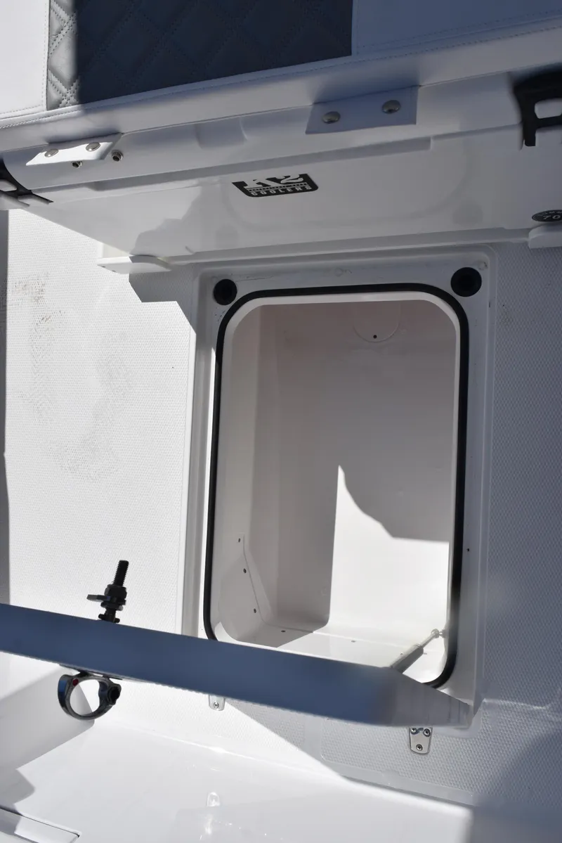 Slide: The Image of 2025 BlackJack 256 Coastal boat storage compartment, open and empty, with white interior. - 16