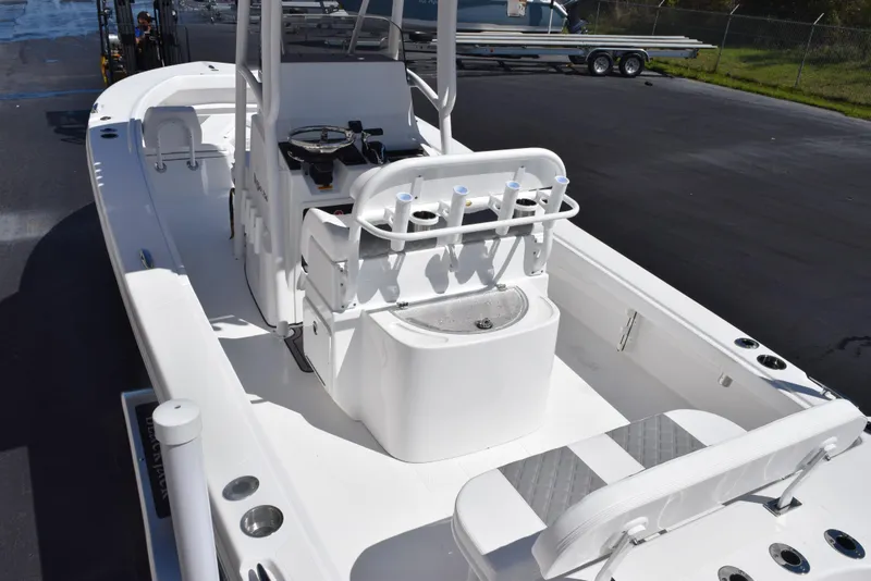 Slide: The Image of 2025 BlackJack 256 Coastal boat interior with seating and console, docked on a sunny day. - 8