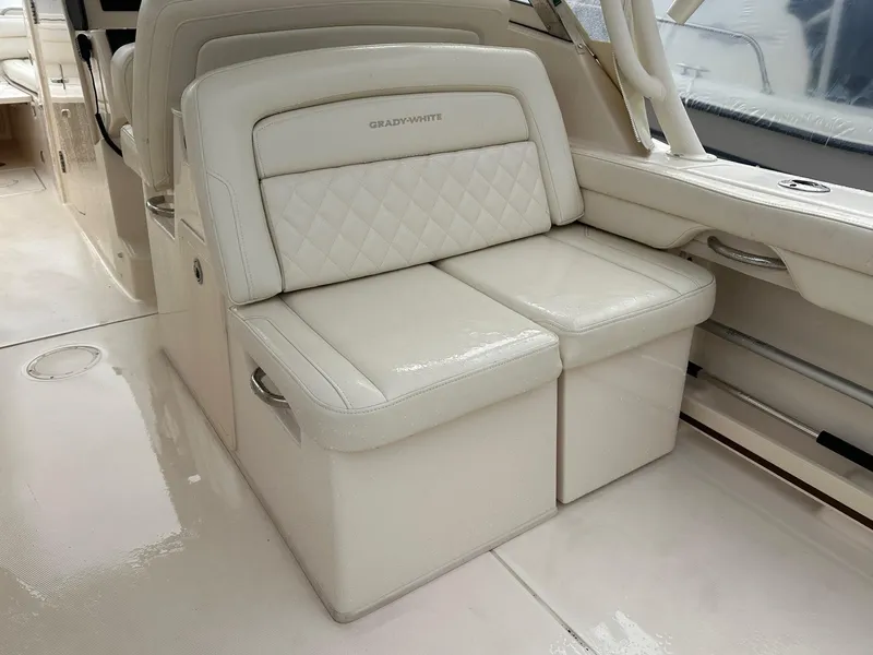 Slide: The Image of 2022 Grady-White 325 Freedom boat interior with luxurious white seating. - 10