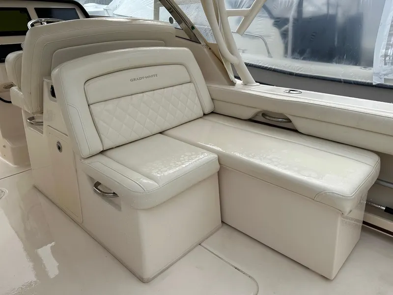 Slide: The Image of Luxurious seating on 2022 Grady-White 325 Freedom boat, featuring elegant white upholstery. - 11