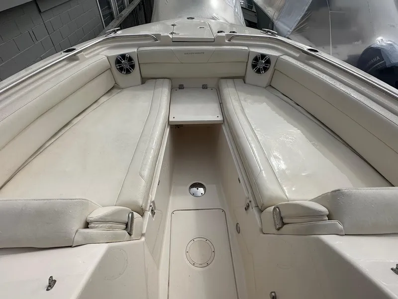 Slide: The Image of 2022 Grady-White 325 Freedom boat interior with white seating and speakers. - 13