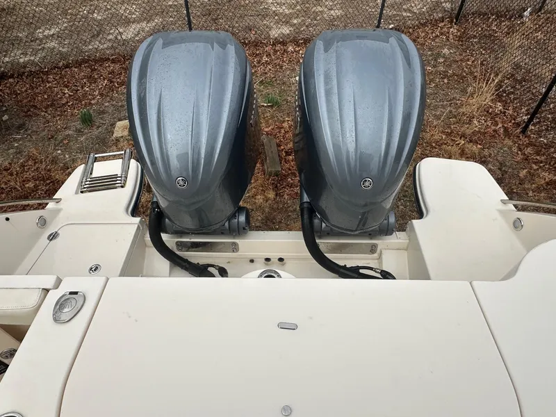 Slide: The Image of 2022 Grady-White 325 Freedom boat with dual outboard engines, rear view. - 16