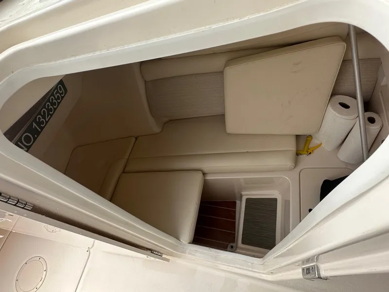 Slide: The Image of 2022 Grady-White 325 Freedom cabin interior with seating and storage space. - 18