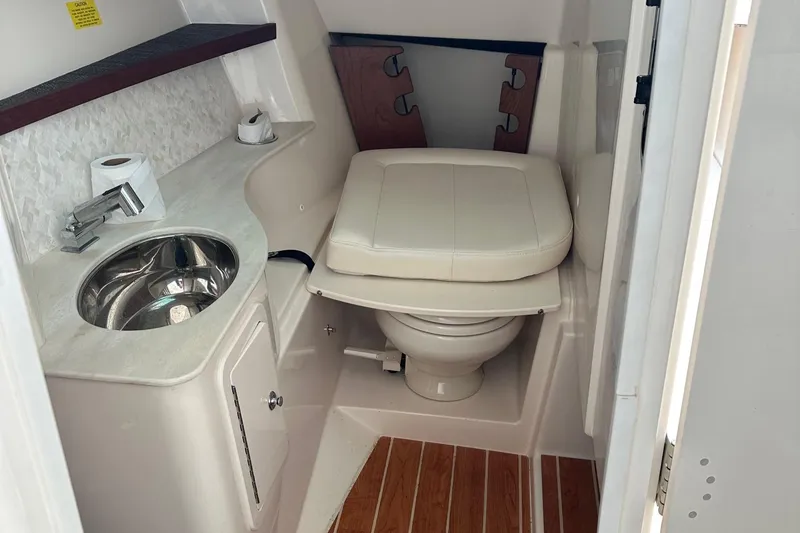 Slide: The Image of 2022 Grady-White 325 Freedom boat bathroom with sink, toilet, and wooden flooring. - 19
