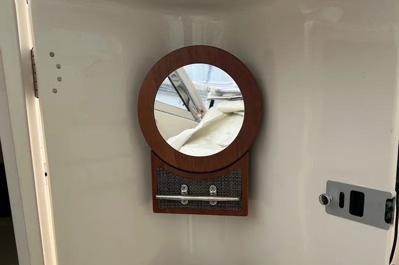 Slide: The Image of Round mirror on 2022 Grady-White 325 Freedom boat interior wall. - 20