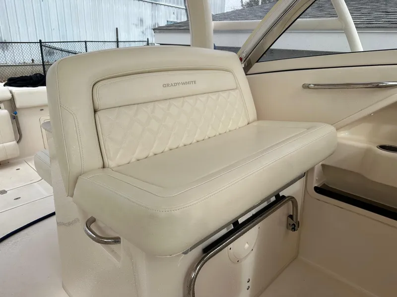 Slide: The Image of 2022 Grady-White 325 Freedom boat interior with luxurious white seating and elegant design. - 7