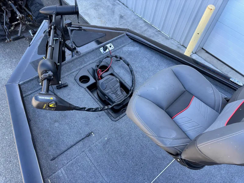 Slide: The Image of 2024 Tracker Pro Team 195 TXW Tournament Edition boat interior with seating and trolling motor. - 2