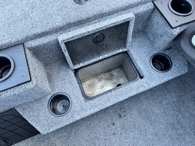 Slide: The Image of 2024 Tracker Pro Team 195 TXW Tournament Edition boat interior with storage compartment and cup holders. - 5