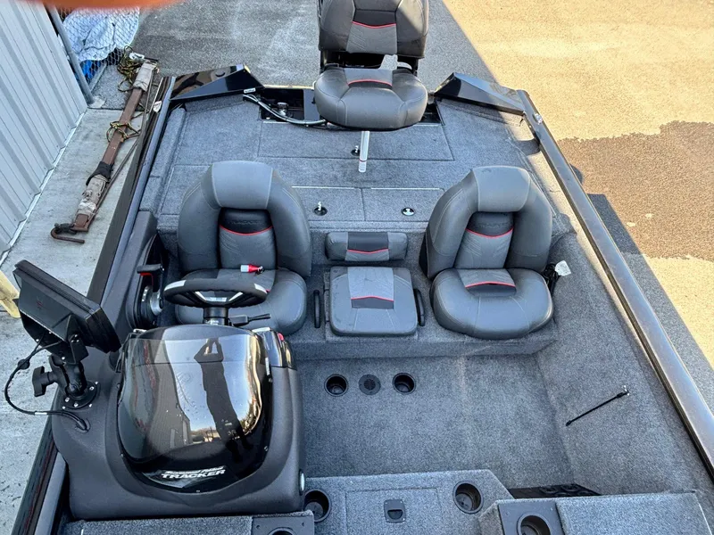 Slide: The Image of 2024 Tracker Pro Team 195 TXW Tournament Edition boat interior with seating and steering console. - 6