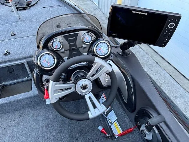 Slide: The Image of 2024 Tracker Pro Team 195 TXW Tournament Edition boat dashboard with steering wheel and Humminbird display. - 9