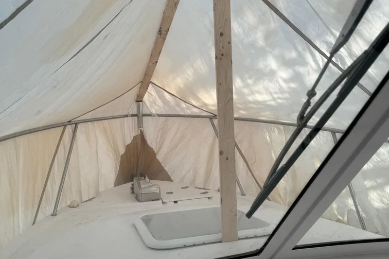 Slide: The Image of 2008 Pro-Line 23 XP boat under protective cover, showing deck and windshield. - 10