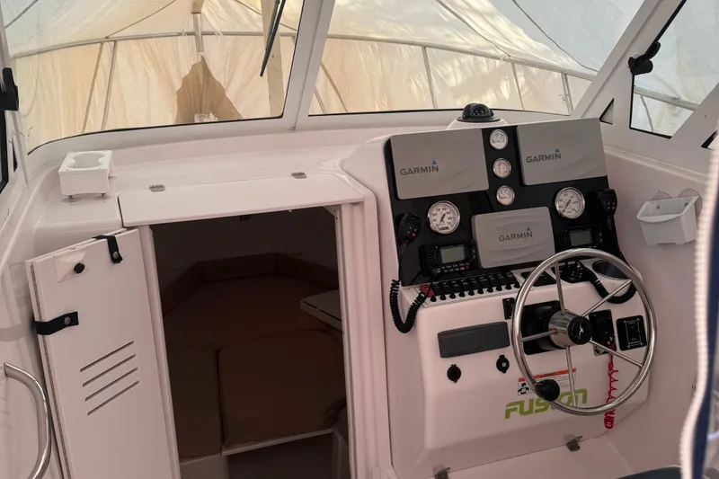 Slide: The Image of 2008 Pro-Line 23 XP boat cockpit with Garmin navigation system and steering wheel. - 3