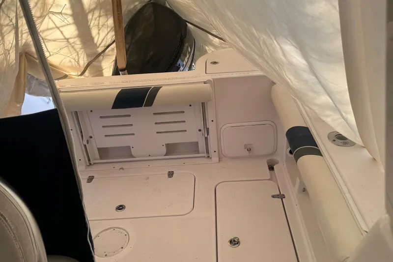 Slide: The Image of 2008 Pro-Line 23 XP boat interior with white seating and storage compartments. - 6