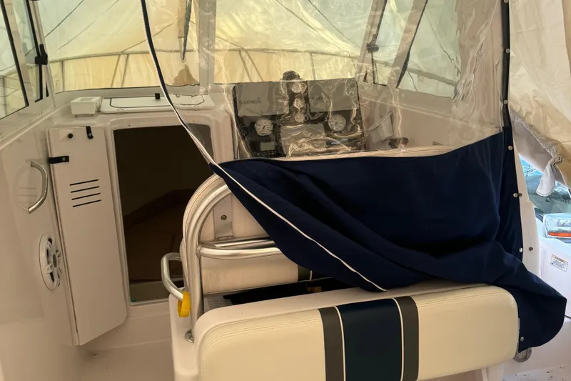 Slide: The Image of 2008 Pro-Line 23 XP boat interior with helm, seating, and protective cover. - 7