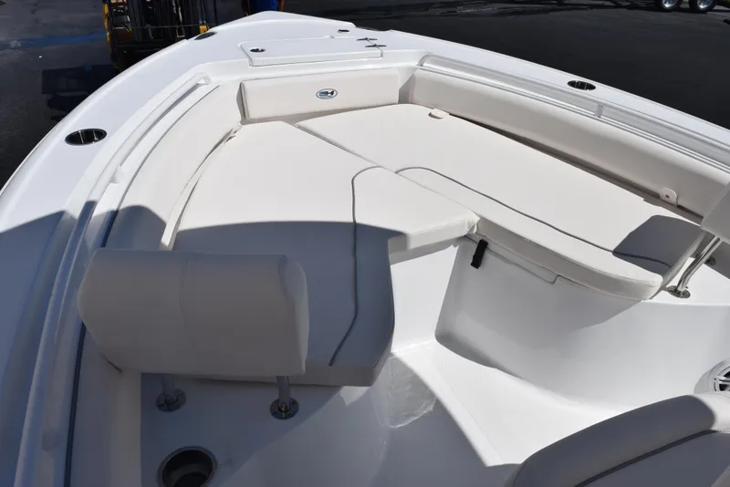 Slide: The Image of 2025 Sea Hunt Ultra 235 SE boat interior with white cushioned seating. - 12
