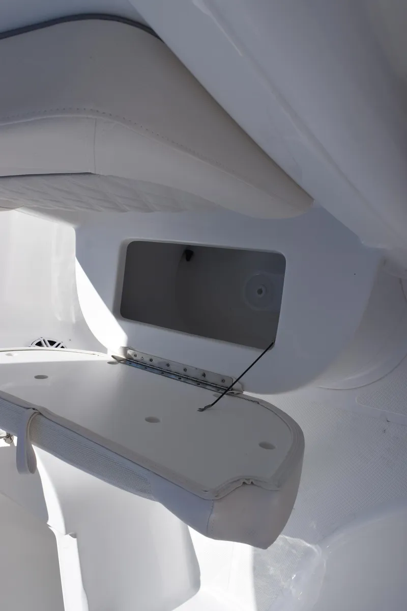 Slide: The Image of 2025 Sea Hunt Ultra 235 SE boat storage compartment, open and empty, showcasing interior design. - 15
