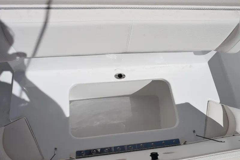 Slide: The Image of 2025 Sea Hunt Ultra 235 SE boat interior with storage compartment. - 18