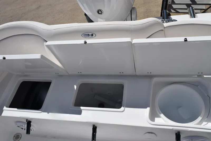 Slide: The Image of 2025 Sea Hunt Ultra 235 SE boat storage compartments and seating area. - 19