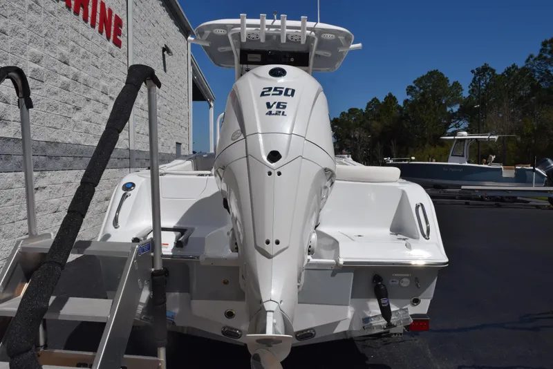 Slide: The Image of 2025 Sea Hunt Ultra 235 SE boat with powerful 250 V6 engine, parked outdoors. - 4