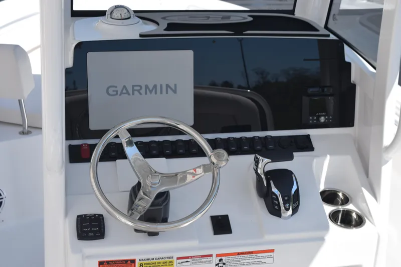 Slide: The Image of 2025 Sea Hunt Ultra 235 SE boat dashboard with Garmin navigation system and steering wheel. - 8