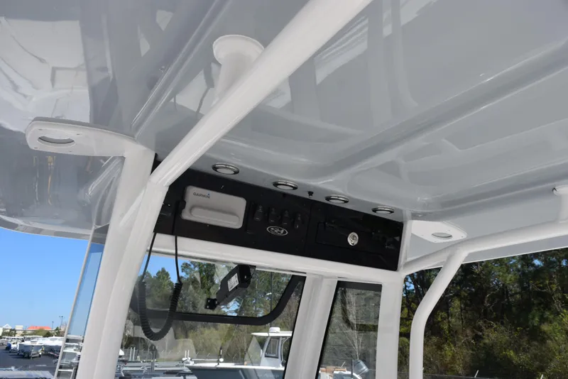 Slide: The Image of 2025 Sea Hunt Ultra 235 SE boat interior with control panel and overhead features. - 9