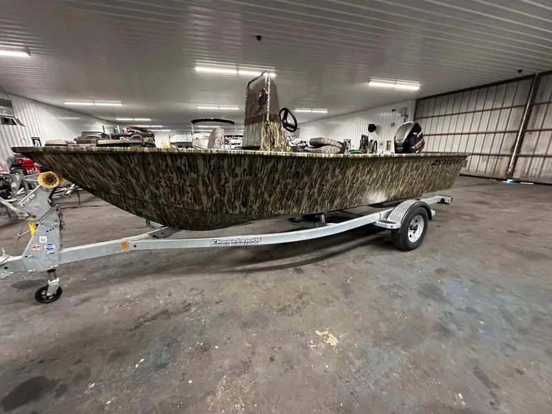Slide: The Image of 2025 Starcraft 180 Freedom CC boat on trailer in indoor storage facility. - 0