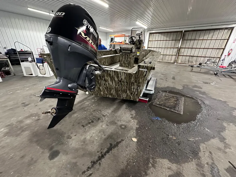 Slide: The Image of 2025 Starcraft 180 Freedom CC boat with Yamaha outboard motor in a garage setting. - 3