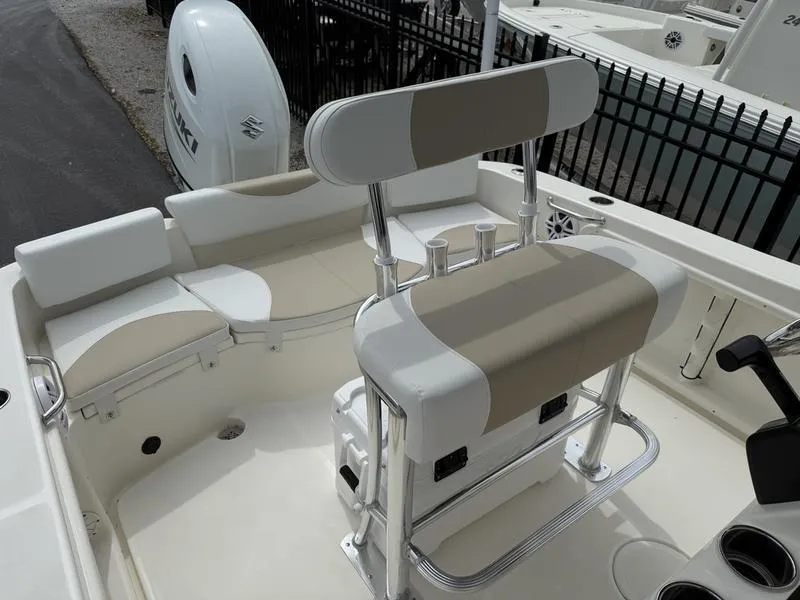 Slide: The Image of 2025 Bulls Bay 200 CC boat interior with beige and white seating, Suzuki engine visible. - 11