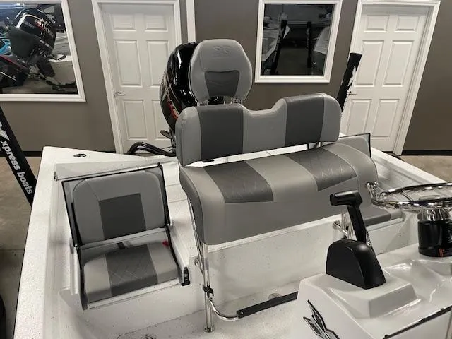 Slide: The Image of 2025 Xpress Hyper Lift H20 Bay boat interior with gray seating and steering console. - 10