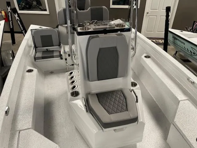 Slide: The Image of 2025 Xpress Hyper Lift H20 Bay boat interior with gray seating and console. - 11