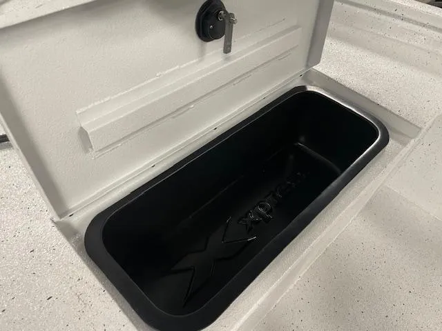 Slide: The Image of Open storage compartment in 2025 Xpress Hyper Lift H20 Bay boat with key lock. - 14