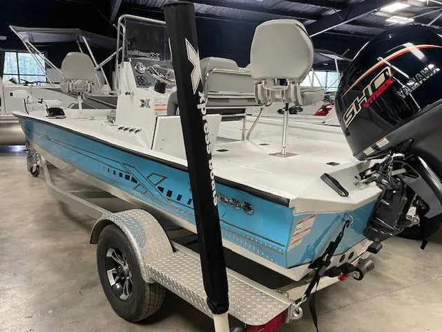 Slide: The Image of 2025 Xpress Hyper Lift H20 Bay boat with Yamaha engine in showroom. - 2