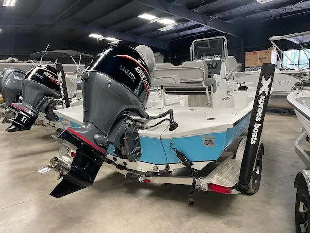 Slide: The Image of 2025 Xpress Hyper Lift H20 Bay boat with Yamaha outboard motor in showroom. - 4