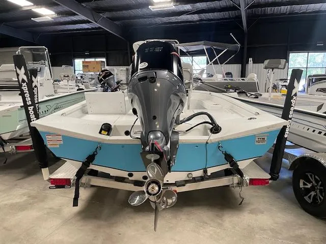 Slide: The Image of 2025 Xpress Hyper Lift H20 Bay boat in showroom, rear view with motor and trailer. - 5