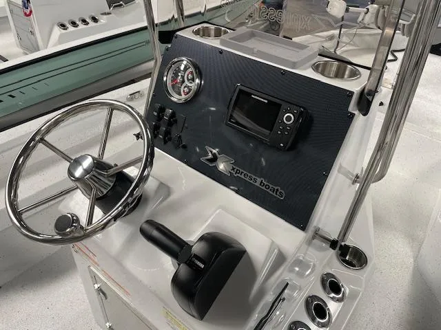 Slide: The Image of 2025 Xpress Hyper Lift H20 Bay boat dashboard with steering wheel and control panel. - 9