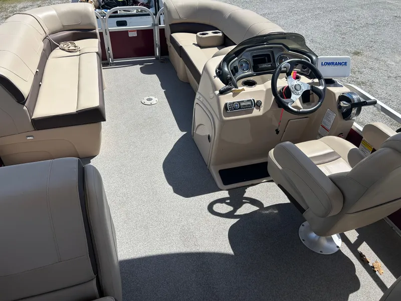 Slide: The Image of 2018 Sun Tracker Party Barge 22 DLX XP3 interior with beige seating and steering console. - 5