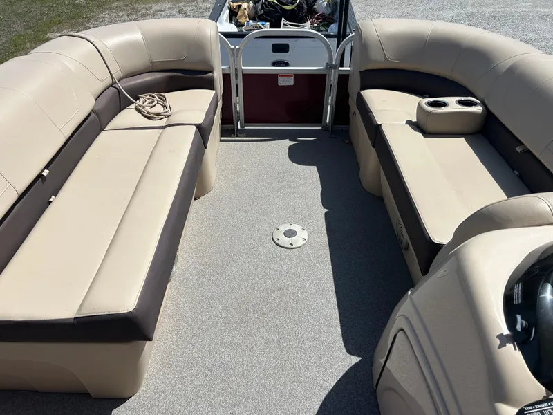Slide: The Image of 2018 Sun Tracker Party Barge 22 DLX XP3 interior with beige seating and cup holders. - 6
