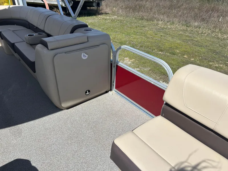 Slide: The Image of 2018 Sun Tracker Party Barge 22 DLX XP3 interior with beige seating and red panel. - 7
