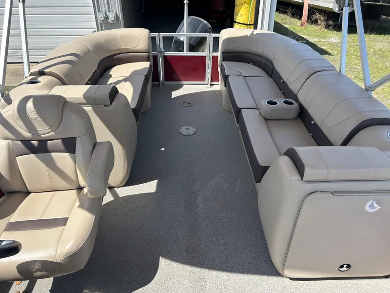 Slide: The Image of 2018 Sun Tracker Party Barge 22 DLX XP3 interior with beige seating and cup holders. - 8