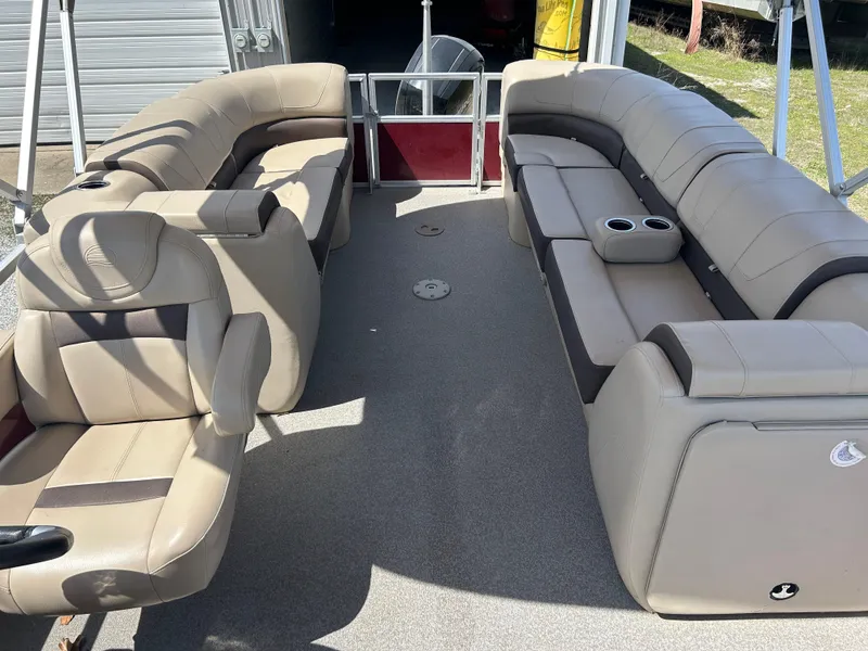 Slide: The Image of 2018 Sun Tracker Party Barge 22 DLX XP3 interior with beige seating and cup holders. - 9