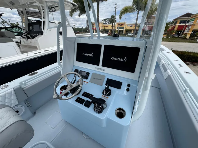 Slide: The Image of 2025 Contender 35 ST boat console with Garmin displays and steering wheel. - 3
