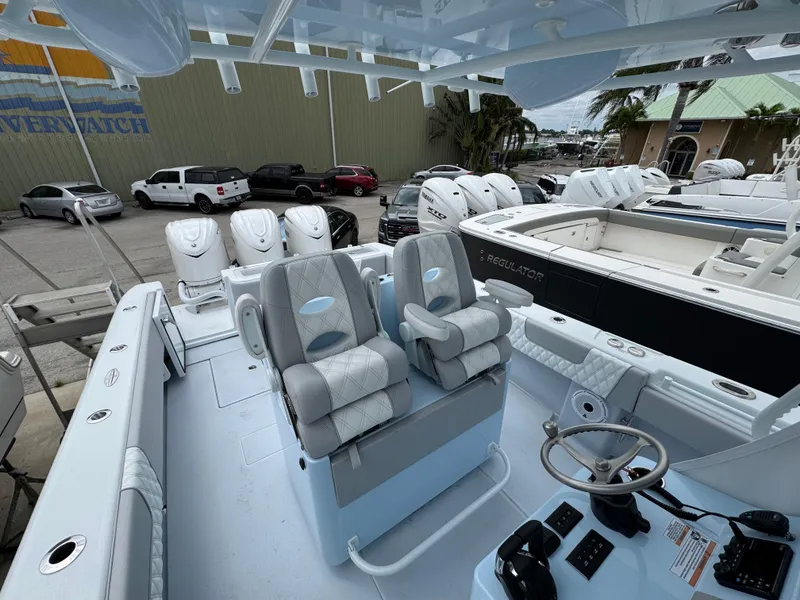 Slide: The Image of 2025 Contender 35 ST boat interior with dual seats and steering console. - 4