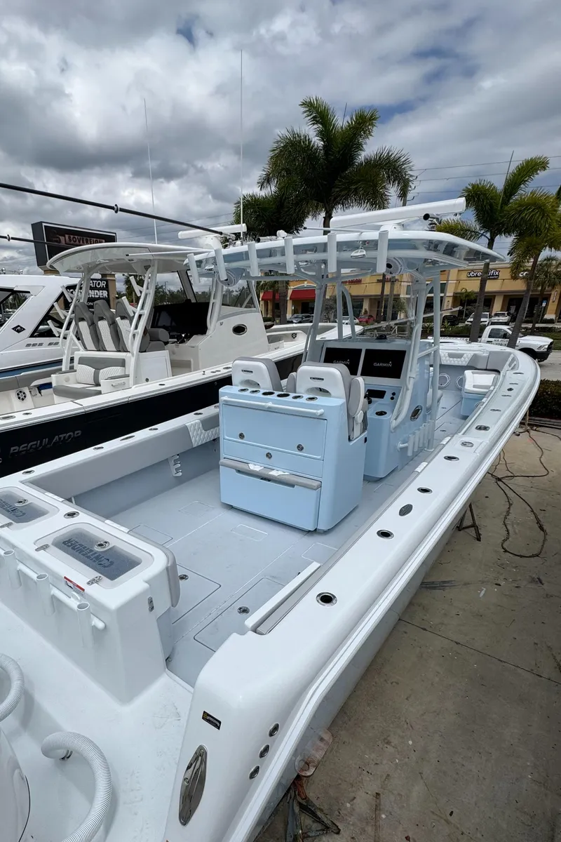 Slide: The Image of 2025 Contender 35 ST boat with sleek design, docked under cloudy skies. - 5
